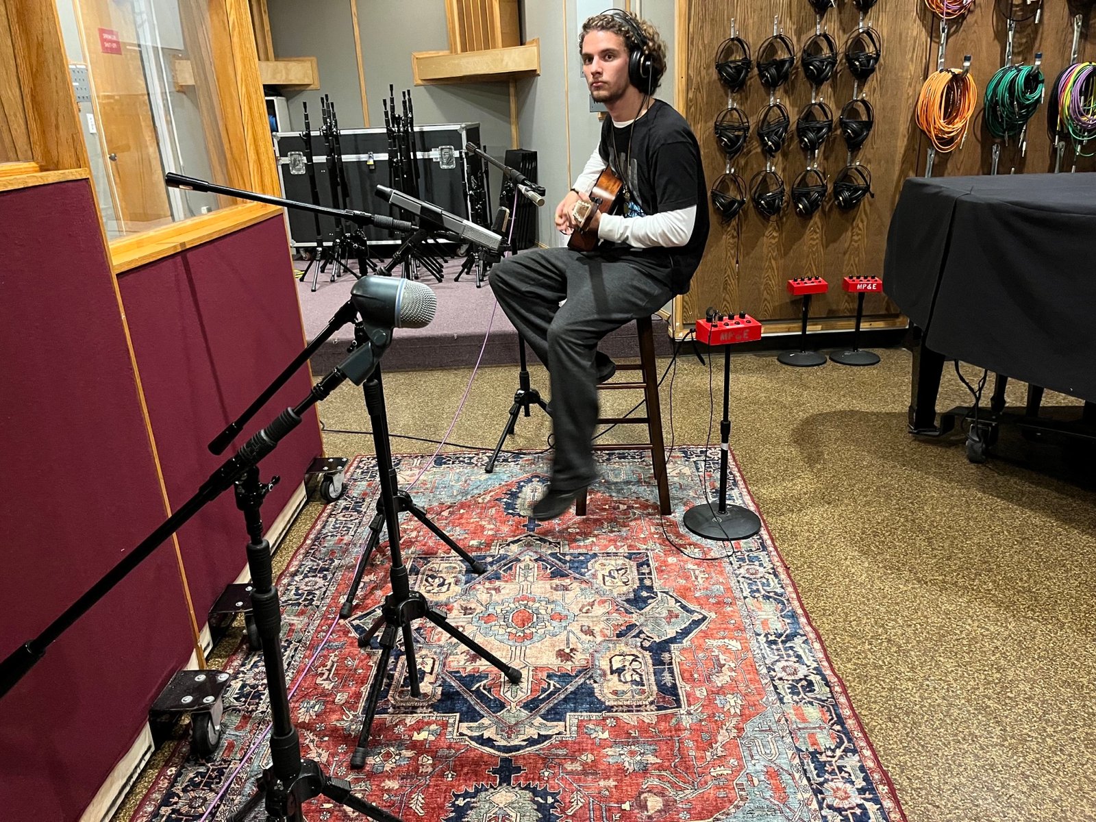 Session musician recording guitar in the live room